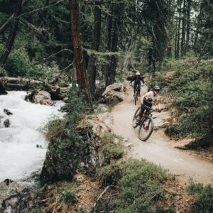 man riding bicycle on river during daytime