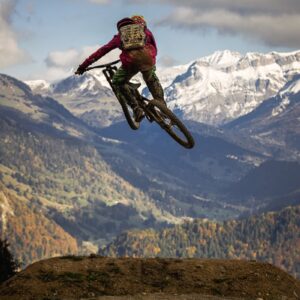 man in red jacket riding motocross dirt bike