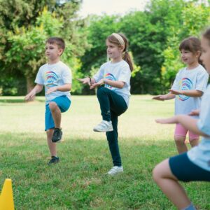 a group of young children playing a game of frisbee